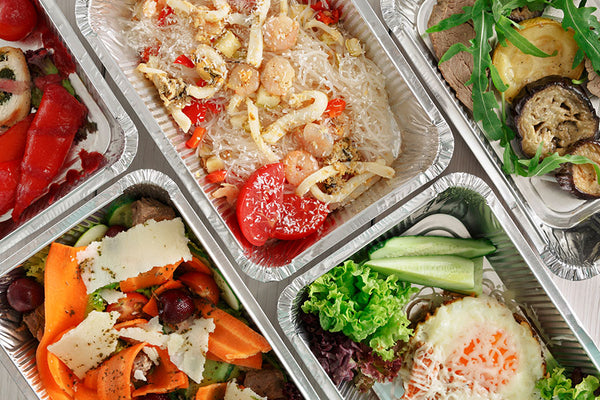 Different types of healthy food on rectangular containers