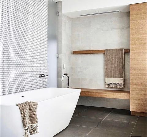 Neutral coloured bathroom with white bathtub