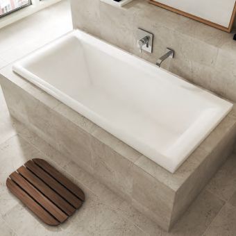 Grey inset bathtub in grey bathroom
