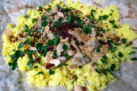 Mansaf in plate with parsley and pomegranate seeds on top