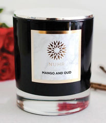 Mango and Oud deluxe candle in front of some red roses