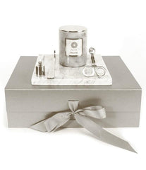 Rose and Oud grey luxury candle, white marble plate, gold wick trimmer and snuffer on a grey gift box