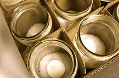 Empty candle containers in a box