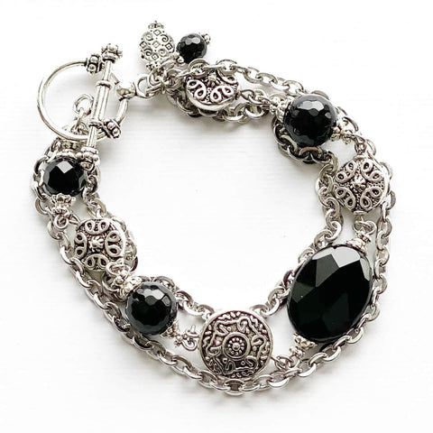 Stainless steel chain and black onyx bracelet with silver pewter beads. It closes with a pewter toggle clasp.