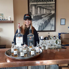 Nicole serving bar at Top Shelf Distillers