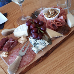 La Vida Local food and wine tour guests enjoy a charcuterie board at Kin Vineyards.