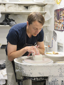 The clay centered on his wheel, Luberger begins to form a vase.  (photo: Norman Kolpas)