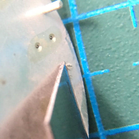 using a penknife to remove the protruding dial legs