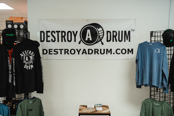 We’re not your average apparel for drummers, marching band students, or drum set players. Drummer’s clothing taken up a notch; Destroy A Drum has a wide selection of drum Tees, drummer's Outerwear, drum performance Headwear, & drumset Accessories with clean cut styles & crazy artwork designs. Shop the best in drum clothing and drummer's outfits for any kind of drummer. Drummer's apparel made with drum designs including t-shirts, hoodies, baseball tees, & more. Drum clothing that speaks for your character & personality on & off the stage; whether you're a drummer, percussionist, in marching band, or representing your passion through our company motto. Destroy A Drum has the drum gear to make you ready to DESTROY