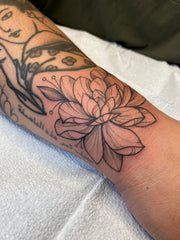 Magnolia tattoo on wrist by Lu Loram-Martin