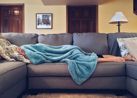person sleeping on grey couch