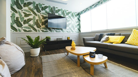 Living room with TV on wall, gray sofa, yellow pillows