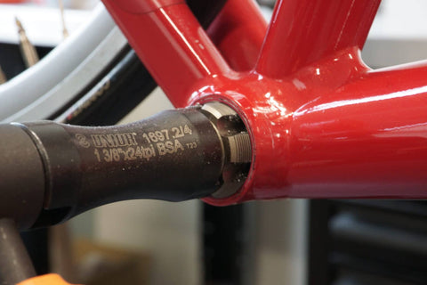 A Unior Bottom Bracket Tap being inserted into a frame