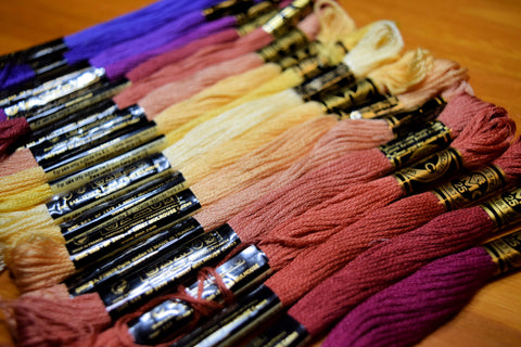 rainbow of embroidery floss shades from yellows to reds and purples