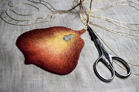 Burgundy and gold iris petal embroidery nearing completion