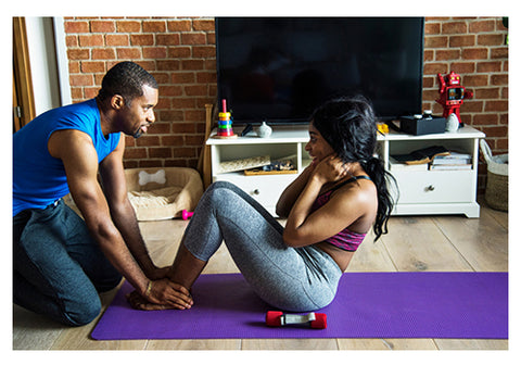 couple exercising at home with yoga mat and dumbbells romantic workout ideas for couples