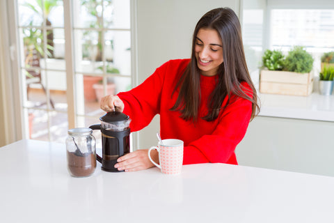Women brewing coffee in a french press Eldorado Coffee