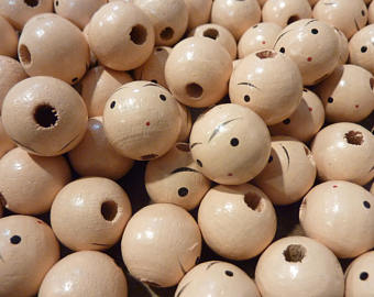 wooden doll heads with faces