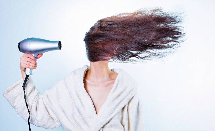Woman blowdrying hair