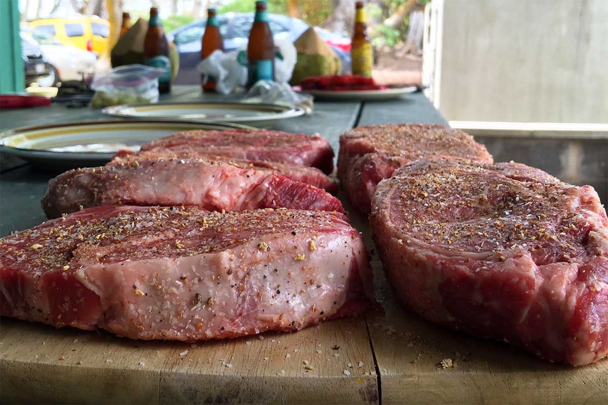steaks ready for grilling at backyard bbq