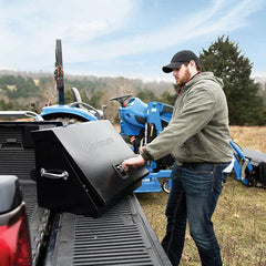 Man opening Montezuma Triangle toolbox on truck