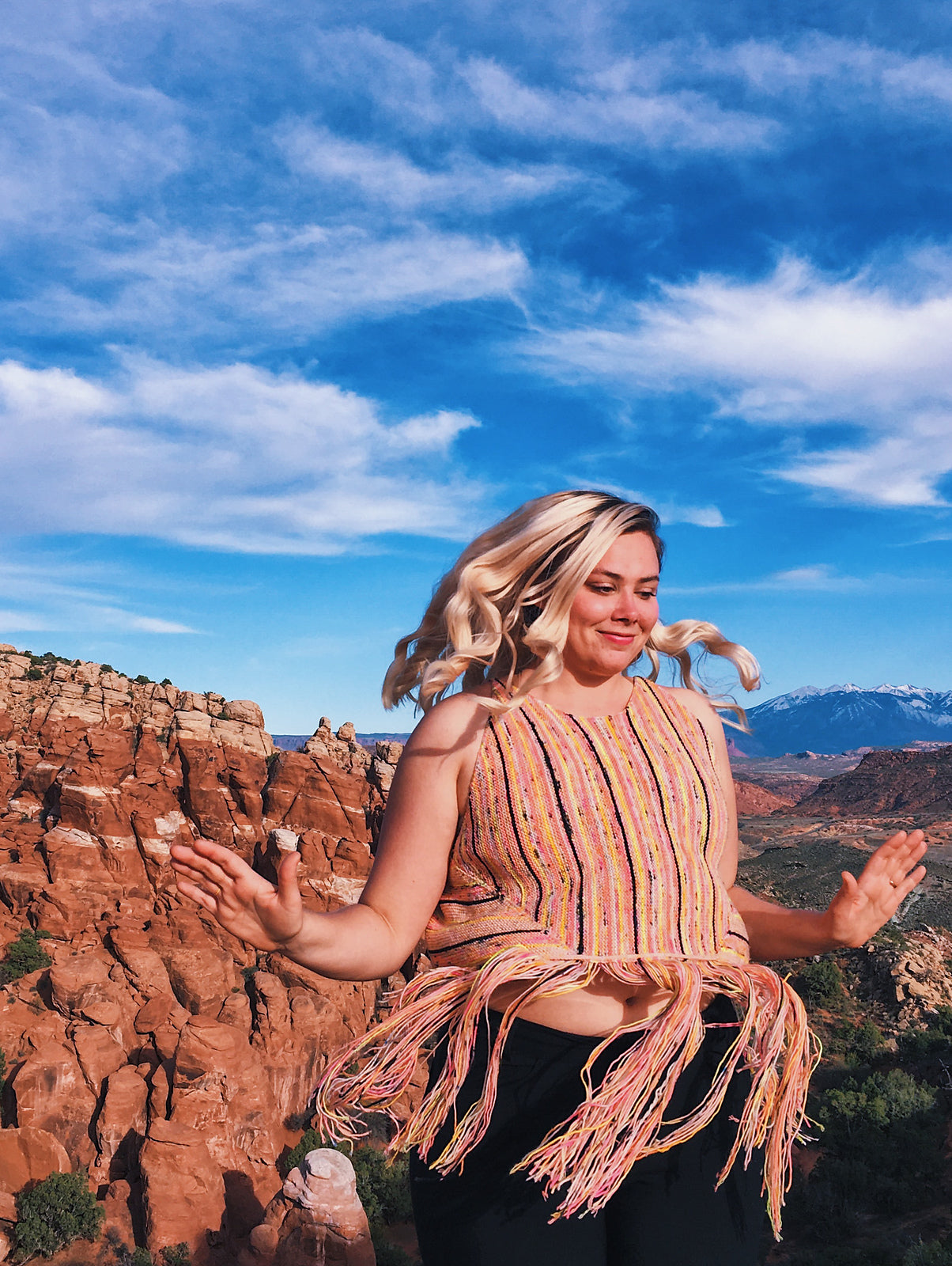 Amalia in her element: a colorful handknit sweater amongst epic nature