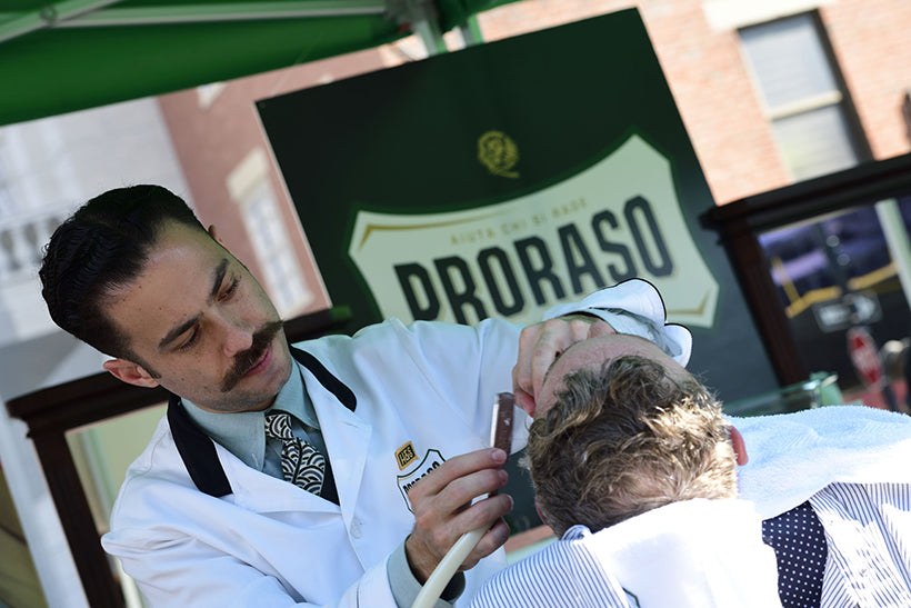 Proraso Master Barber Michael Haar shaving a reclined in a barber chair in our mobile barbershop