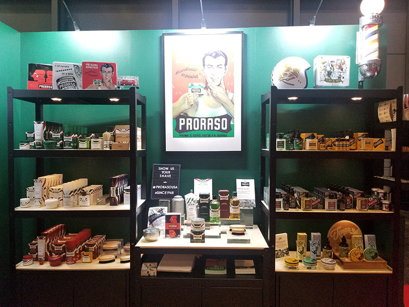 Proraso tradeshow set up with full line of products on shelving and brand posters decorating the walls.