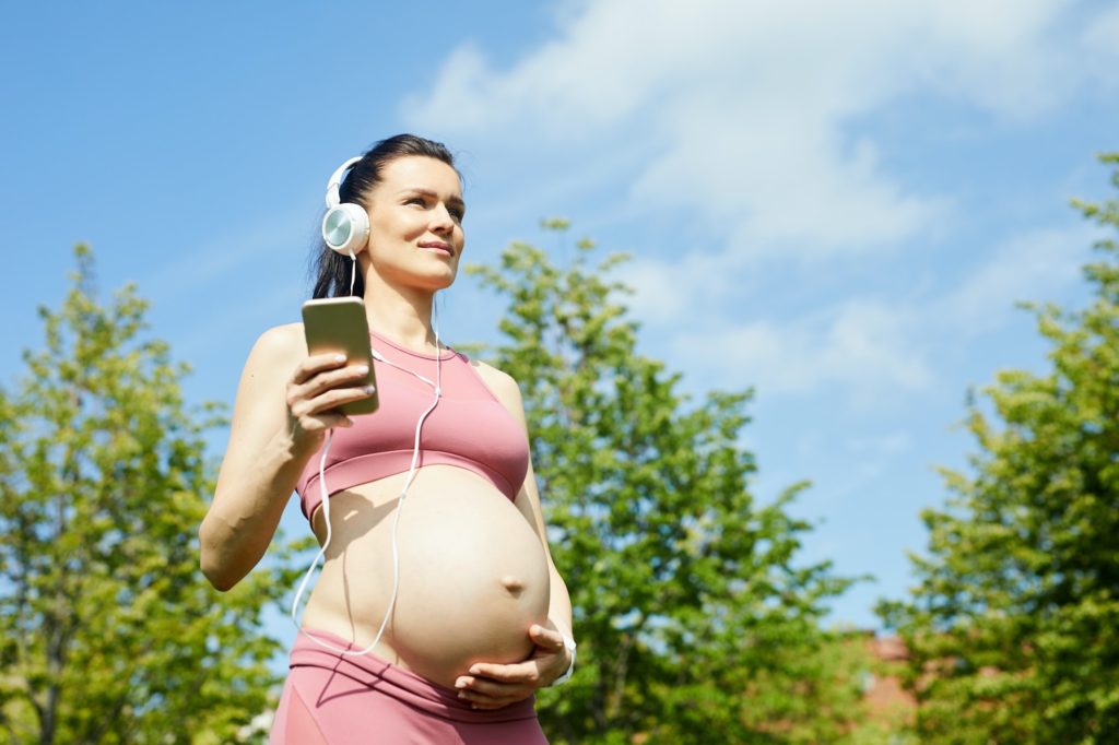 Pregnant woman enjoying the music
