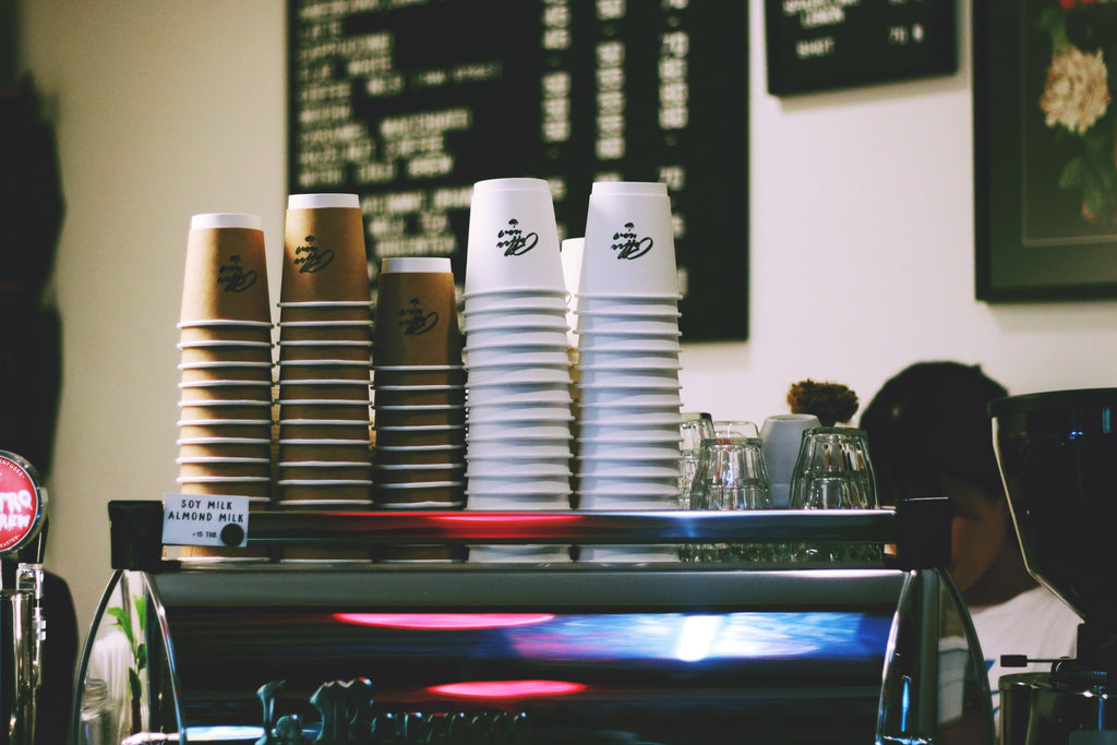 plastic cups on a coffee machine
