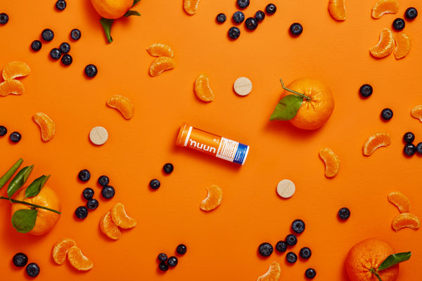 Nuun Immunity tube surrounded by fresh fruit and tablets