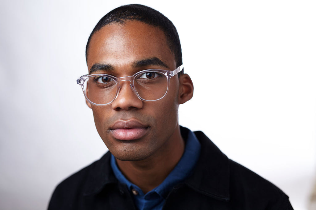 Man wearing blue light blocking glasses