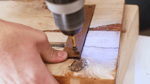 A man creating a wall sconce