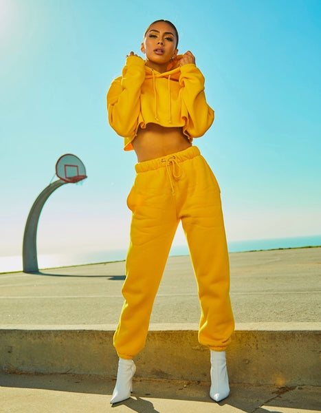 Girl in yellow tracksuit with white boots.