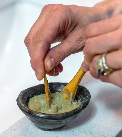 mixing of green clay masque for deep skin cleansing