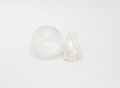 clear quartz crystal sphere and cluster