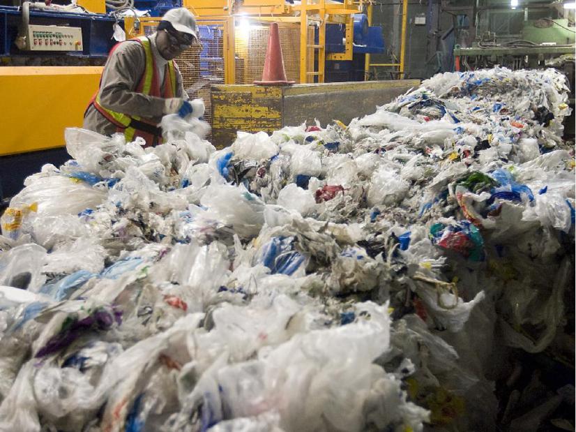 Worker secures plastic bag bundles at the Montreal recycling plant on November 25, 2008. 