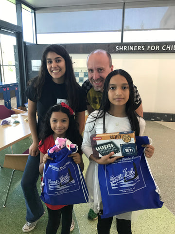 Children receiving WE Games chess gifts at Shriners Children's Medical Center Pasadena