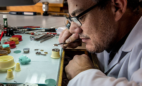 Man preforming a watch face repair