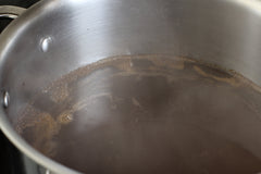 simmering beef stock on the stove