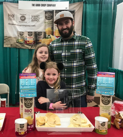 Matt and two of hi daughters at a Good Crisp company stall with sample products