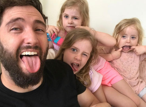 Selfie of Matt and his three daughters making silly faces at the camera