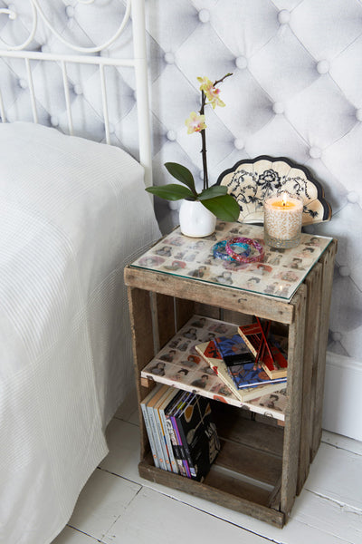 Vintage apple crates can be upcycled into bedside tables with a storage shelf and glass top.