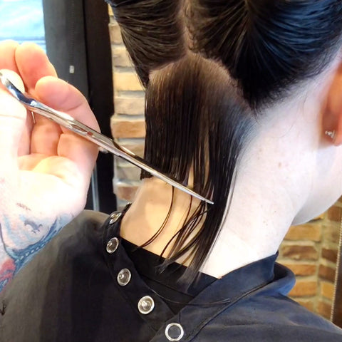 Using ARC Scissors, cut the neckline of your bob wet with zero elevation