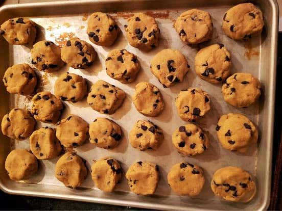 sheet pan with cookie dough. peanut butter cookies made with classic creamy peanut butter.