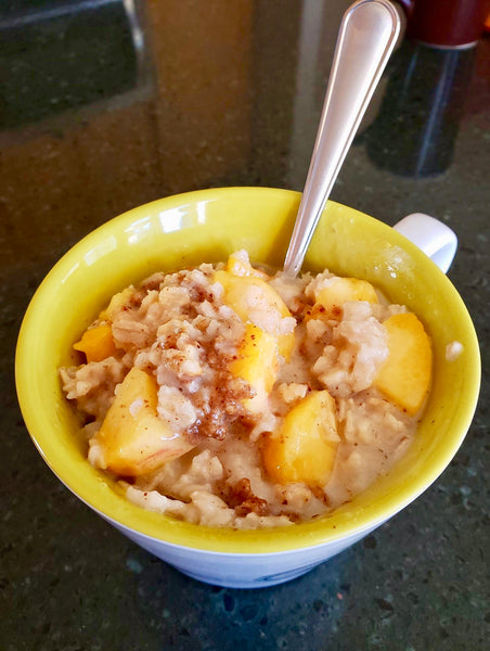 Gluten-free, dairy-free peach "cobbler" made with Colorado peaches, Cinnamon Almond butter, and oats cooked in milk or coconut milk.