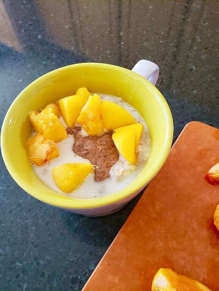 Peach "cobbler" with fresh Colorado peaches, Cinnamon Almond butter and oats cooked in milk.