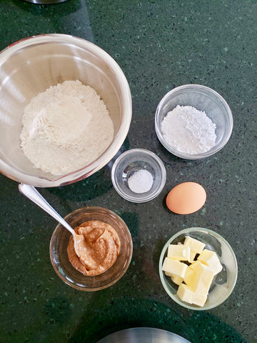 Fresh ingredients for apple tart dough - egg, flour, butter, salt, powdered sugar