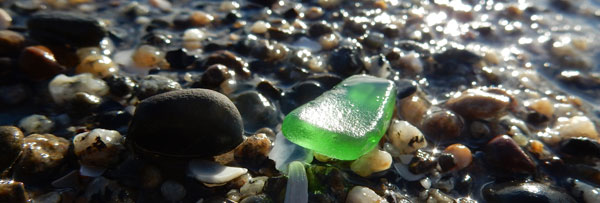 green beach glass on beach