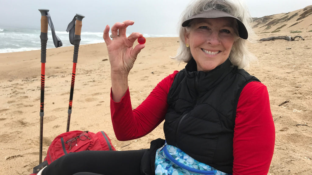 sheree on the beach with walking sticks